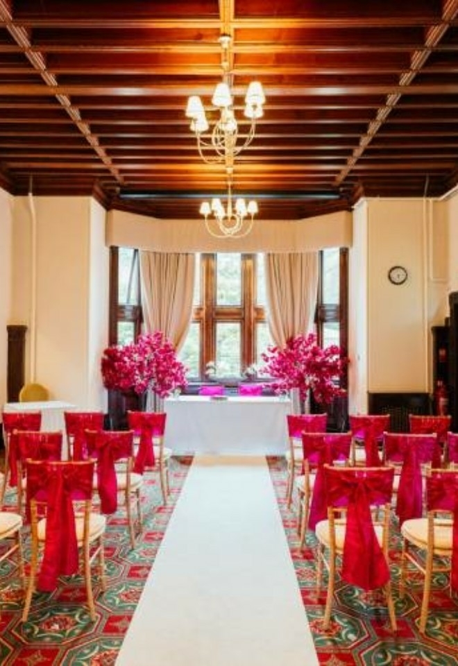 Somerleyton Suite Ceremony with dark pink chair bows and matching blossom trees- Sprowston Manor Norwich