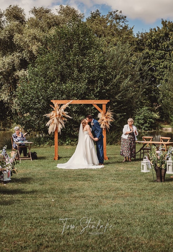 Bride and groom under wedding arch