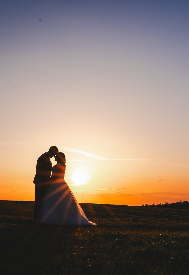 bride and groom silhouette at sunset