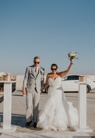 bride and groom in sunglasses, arrive at their wedding reception on a yacht in cyprus