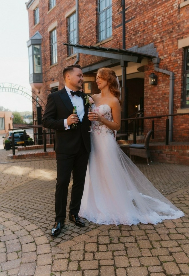 Couple celebrating their marriage outside Hotel Du Vin Newcastle