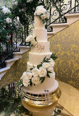six tier buttercream wedding cake with fresh White roses at Hedsor House made by Celebration Cakes by Catherine Scott in Buckinghamshire