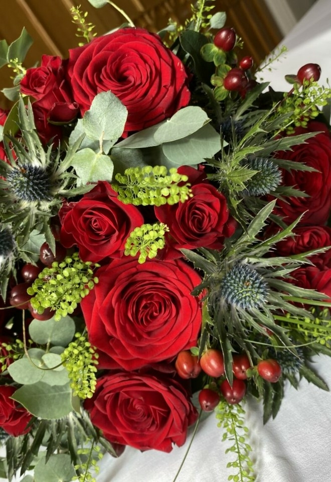 red flower bouquet by hire heaven