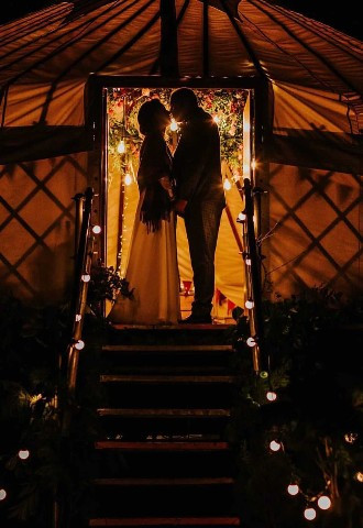 bride and groom at yurt door