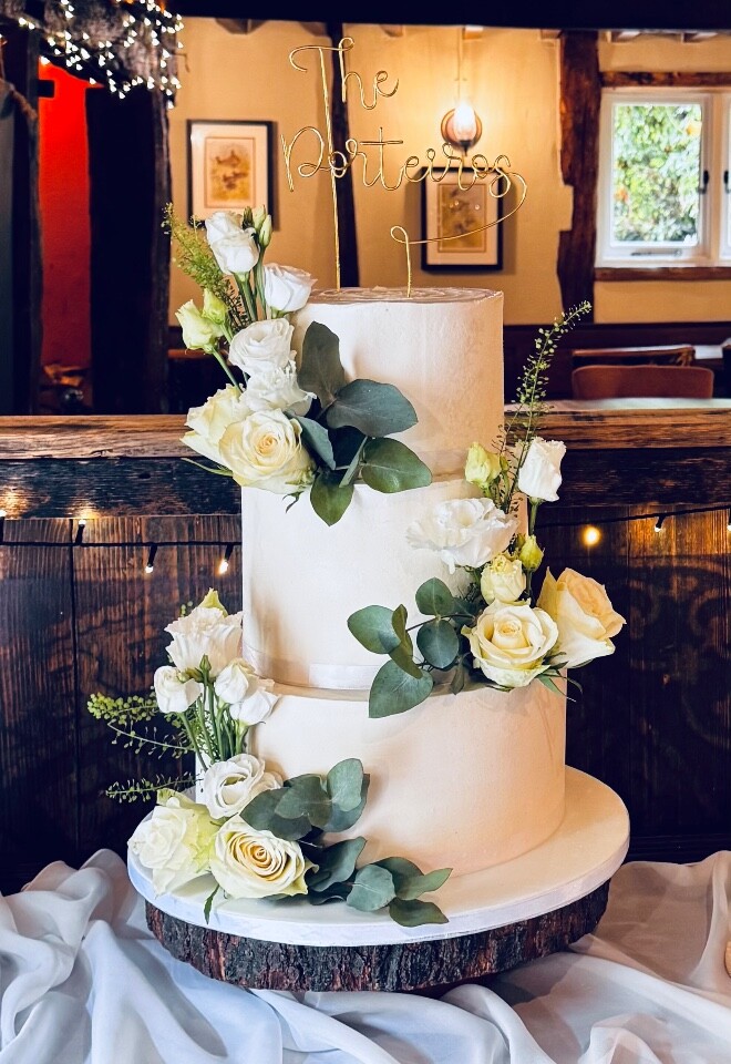 Buttercream 3 tiered cake decorated with matching flowers from the bridle bouquet 
