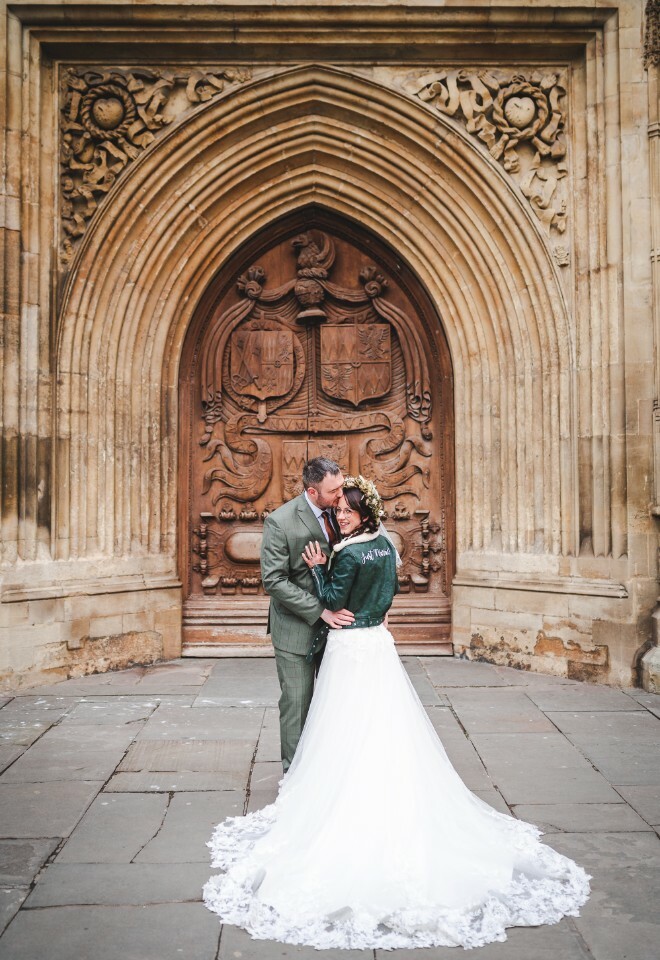 bride and groom outside bath abbey
