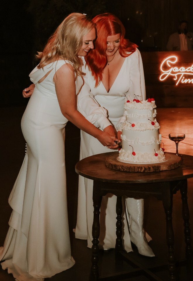 Brides cutting wedding cake
