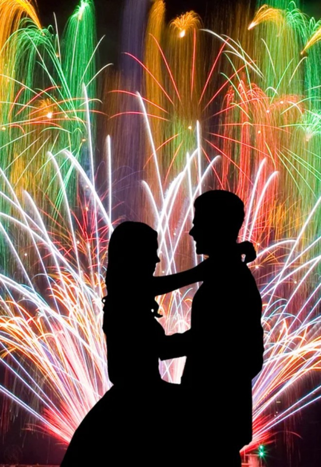 Bride and groom silhouetted in front of a spectacular wedding fireworks display by Berkshire-based Star Fireworks, specialists in wedding fireworks, drone displays and special effects.