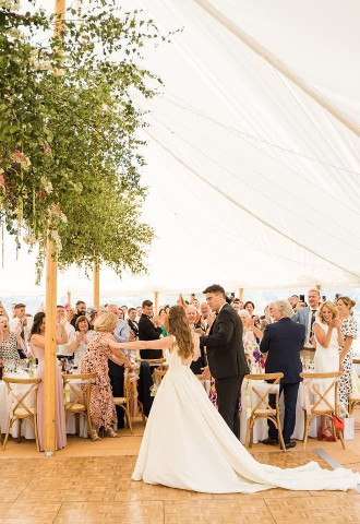 bride and groom entering yurt reception