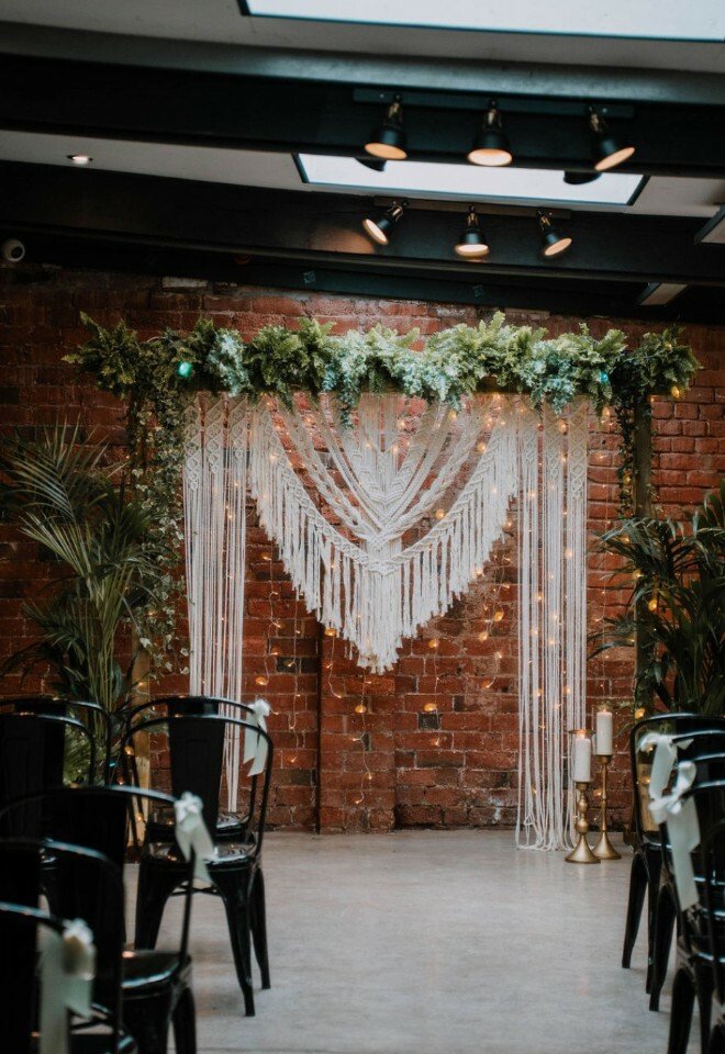 Plant themed wedding decor at top of aisle