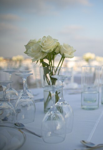 Wedding breakfast table set up with white roses in sunny cyprus, exclusive yacht weddings
