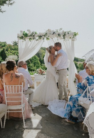 Bride and Groom Kiss at their sunny wedding ceremony in cyprus, exclusive yacht weddings