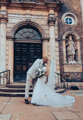 Couple kiss outside of Worcester Guildhall on wedding day