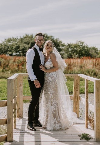Bride and groom pose for their wedding photography at Henblas Country Park, Anglesey, North Wales