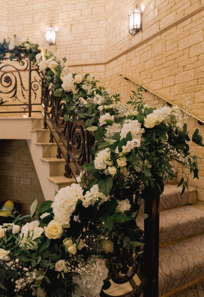 Stunning staircase flowers at pennyhill park. Fresh flower garlands