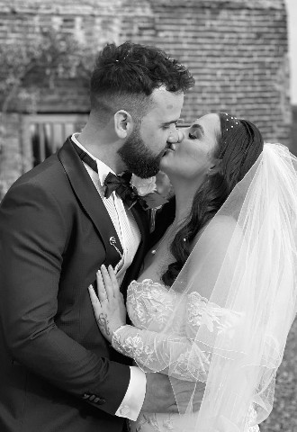 Bride and groom sharing a kiss captured by MB Events