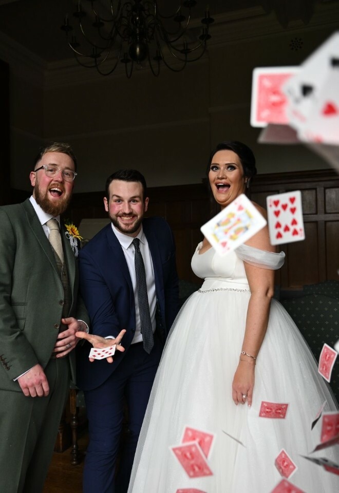 having a photoshoot with the wedding couple - playing cards are falling in front of the camera