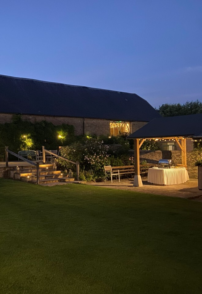 The grounds and barn at an exclusive Oxfordshire barn wedding venue