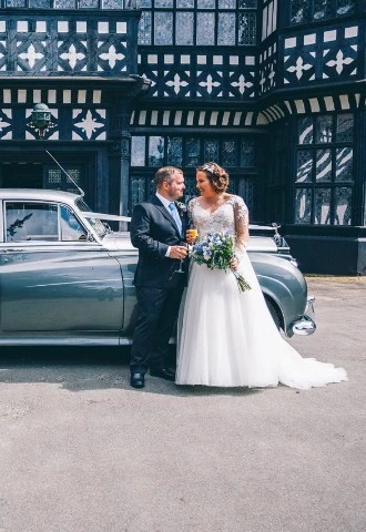Bride and Groom with Car outside Bramall hall