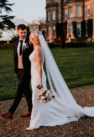 Wedding couple walking in grounds taken by Gingersnaps Photography Surrey