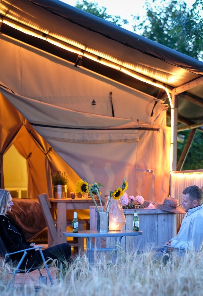 Couple sitting outside tent marquee