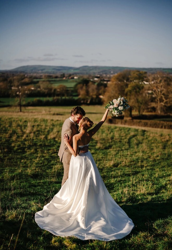 Romantic outdoor wedding photo on couple in the Somerset countryside at Henlade House wedding venue near Taunton.