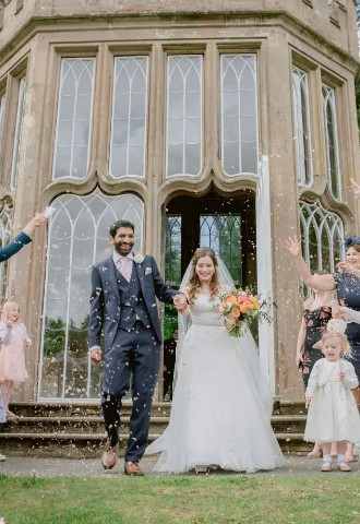 bride and groom being showered in confetti after their wedding ceremony at culzean castle in ayrshire scotland