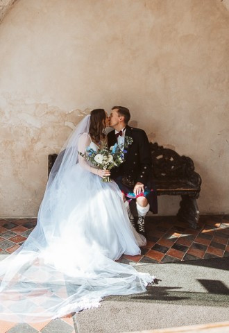 Bride and groom share a kiss at Bisham Abbey, Berkshire