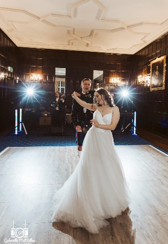 Bride and groom share their first dance at Bisham Abbey, Berkshire