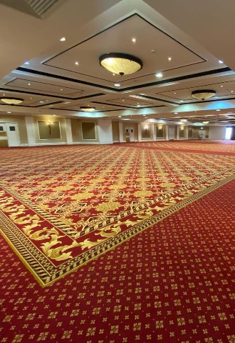 Large ballroom with red and gold patterned carpet at Voco St Johns Solihull