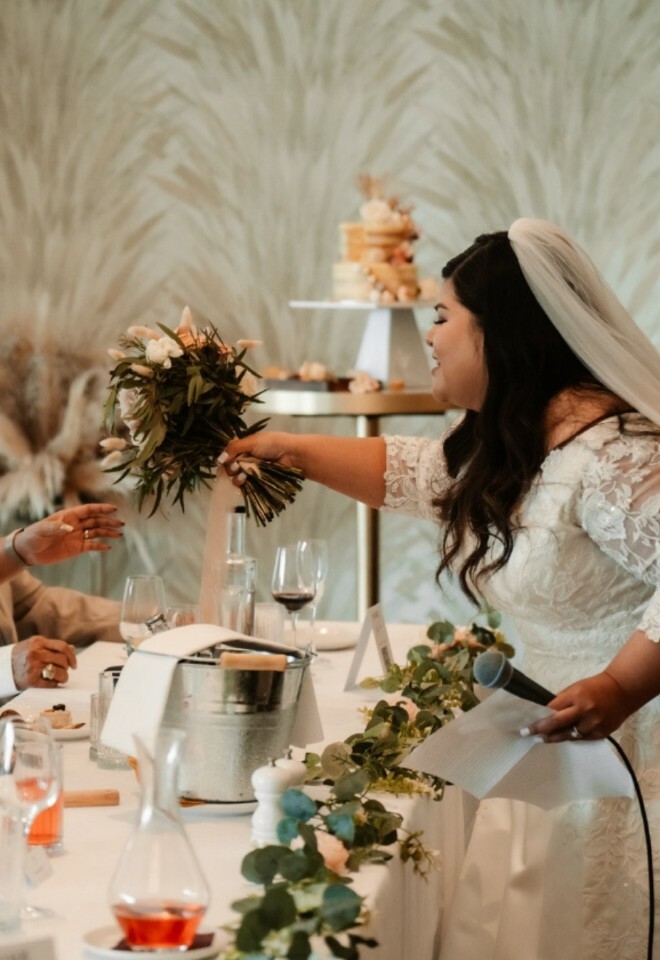 brides speech handing over her bridal bouquet to a guest at The Nici Hotel bournemouth
