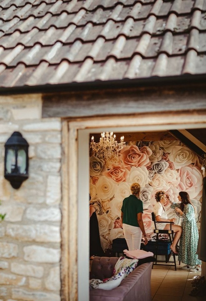 Bride getting ready in the dressing room at Kingscote Barn