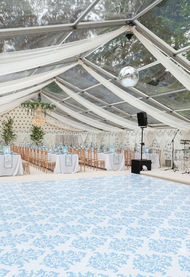Luxury clearspan marquee with custom blue and white floral patterned dancefloor 