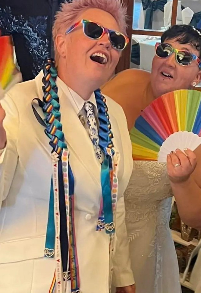 two brides in white with handfasting and fan