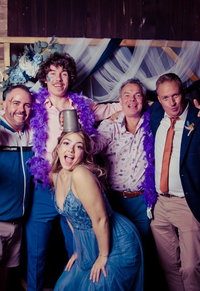 Evening wedding guests pose for a fun photo in the evening studio by Paul Griffiths Photography