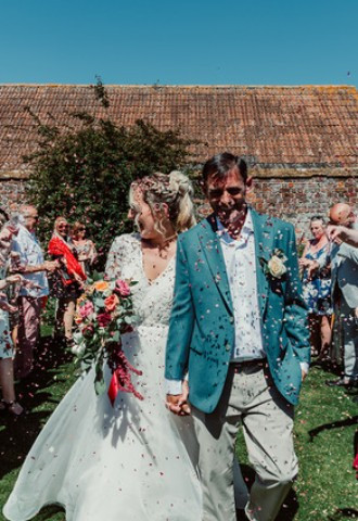 Bride and Groom being showered in confetti at Midelney Manor