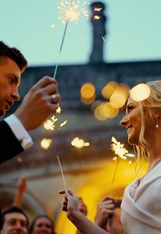 Bride and groom pose with sparklers