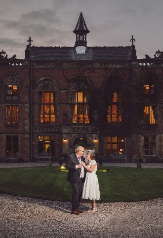 older bride and groom pose outside their country house wedding venue in the evening for their wedding photography, north wales andrew baines wedding photography