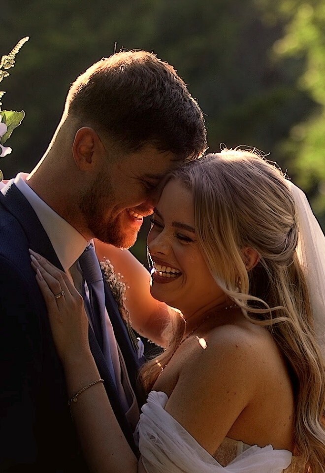 Bride and Groom hugging and smiling at Rivervale Barn