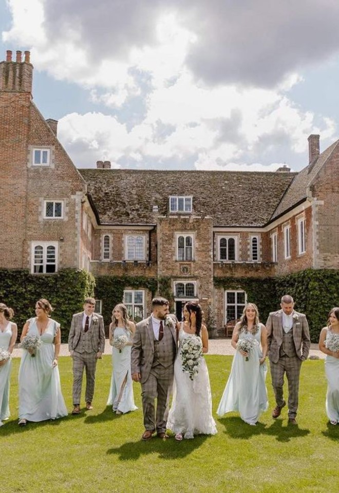 Bride and groom with bridesmaids and groomsmen outside of Hockwold Hall wedding venue