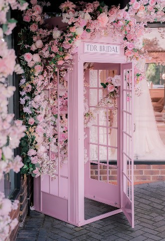 Pink phone box with flowers outside TDR Bridal Birmingham - The Dressing Rooms