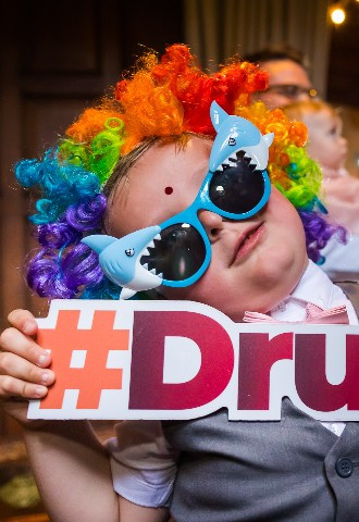 funny photo at a child holding a drunk sign at a wedding reception