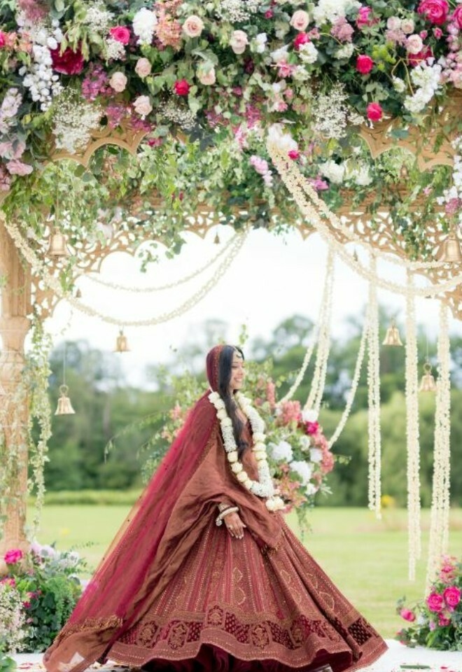A bride underneath a Mandap on the lawns of the Mansion House.