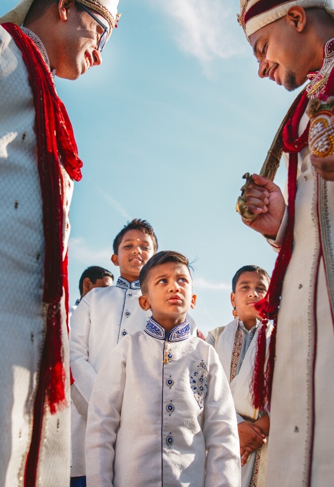 Multicultural wedding celebration with children and guests during an outdoor wedding procession