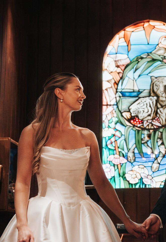 Bride and Groom in Enchanted Library in front of Retro Stained Glass Window