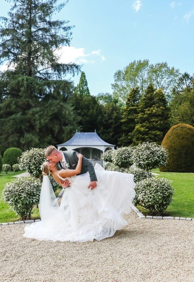 groom holding the bride back and kissing her at Wennington Hall 