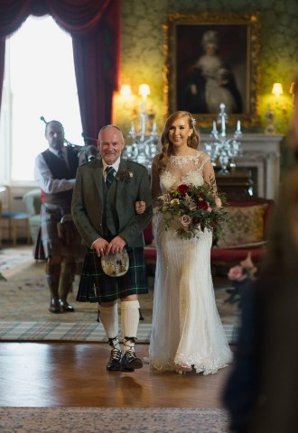 Bride and her father walk down the aisle at Fyvie Castle, Aberdeenshire