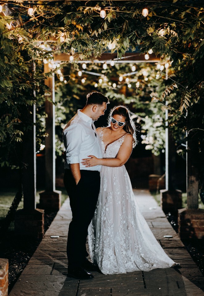 Bride and Groom under the Pergola in the Walled Garden at Vaulty Manor, Essex