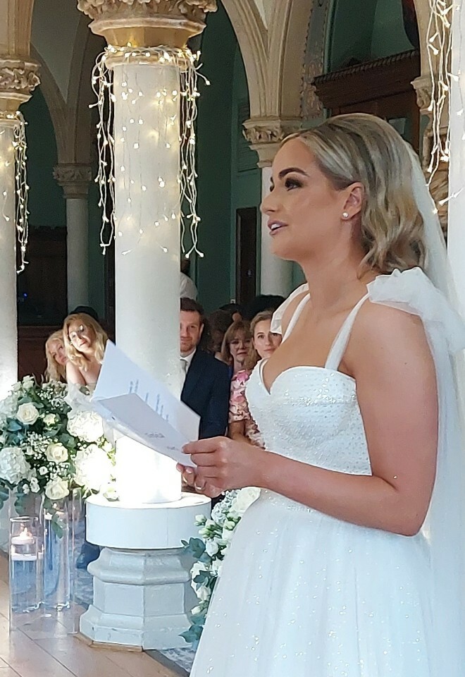 beautiful bride reads her vows to husband