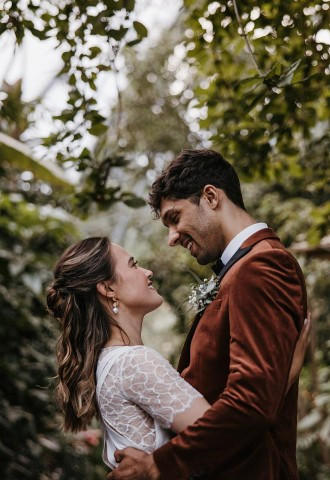 Couple with backdrop of Eden Project lush greenery on wedding day